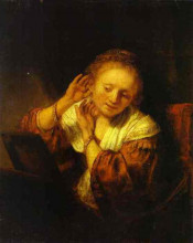 Репродукция картины "a young woman trying on earings" художника "рембрандт"